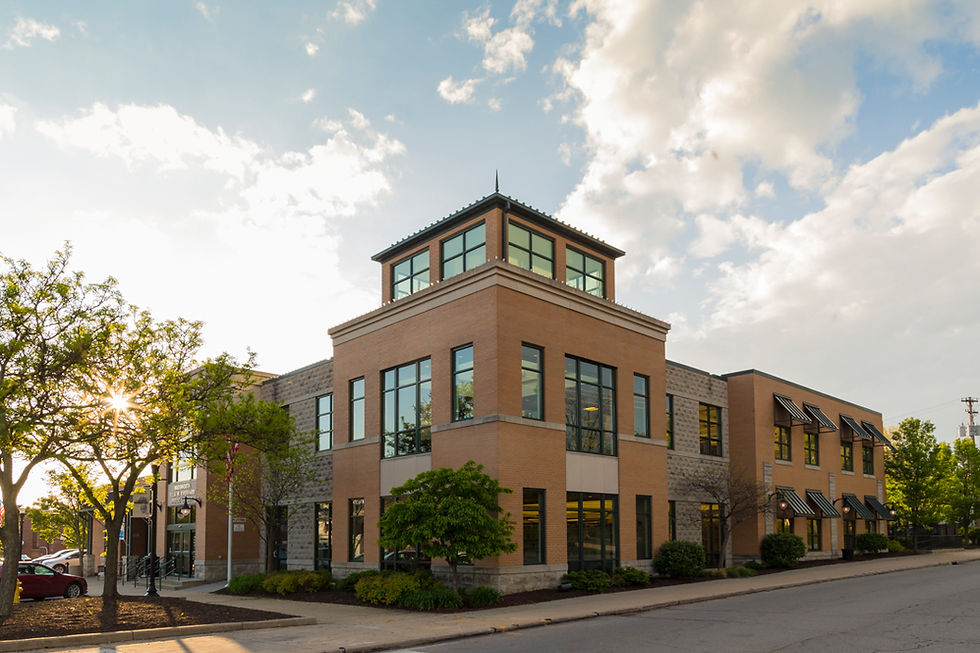 Exterior view of a Wadsworth Public Library building with large windows and sky.